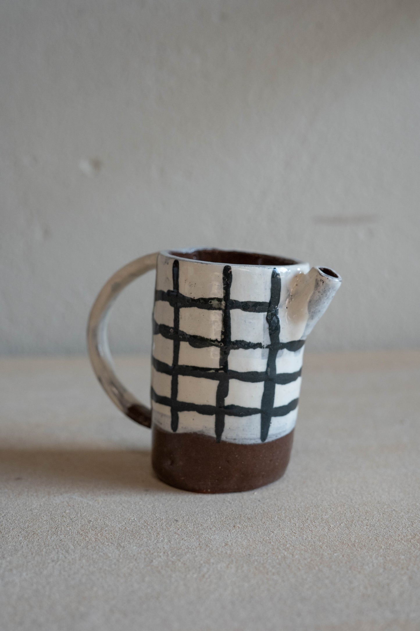Small checkered jug with handle