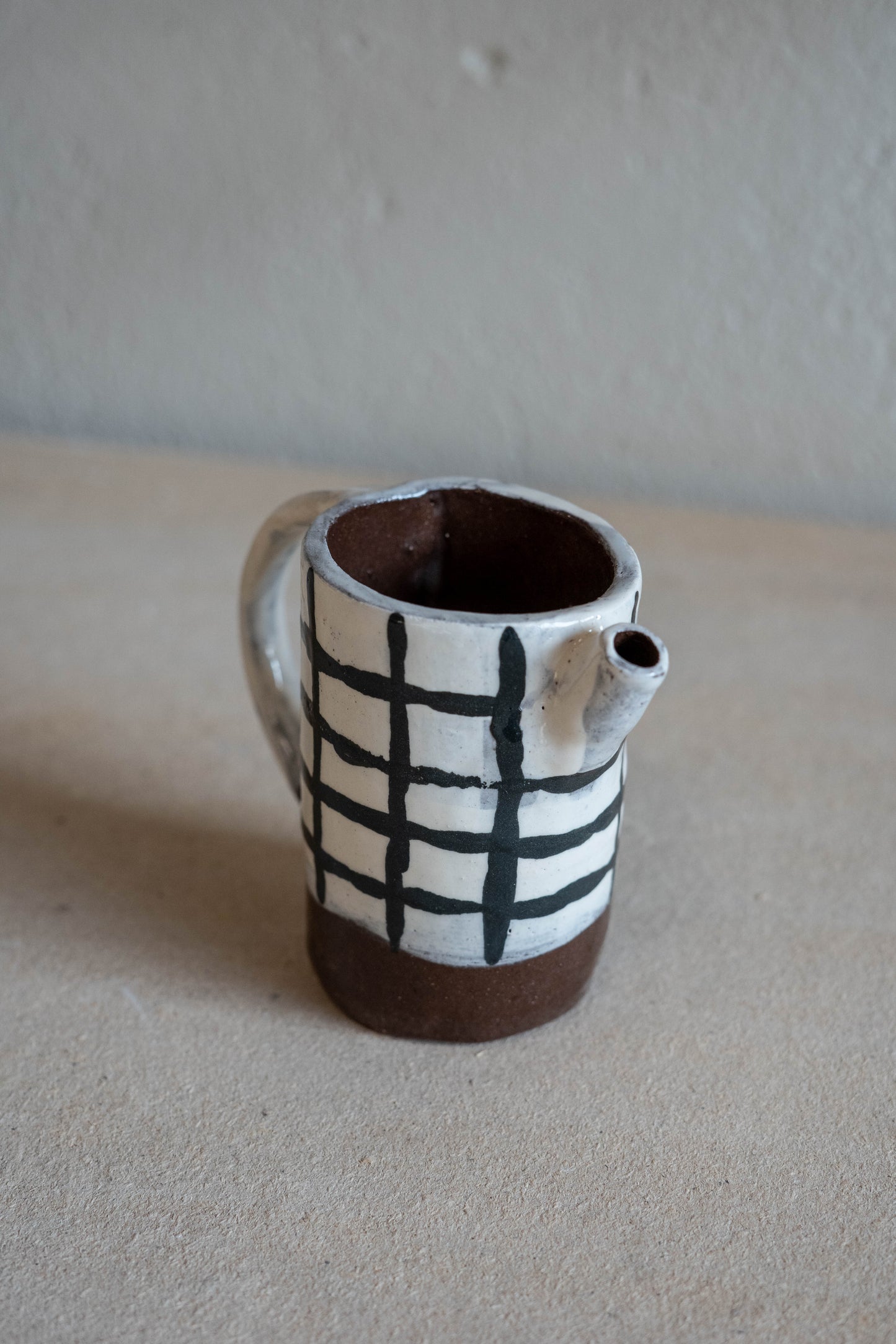 Small checkered jug with handle